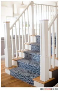 wood stair with white risers and blue stair runner
