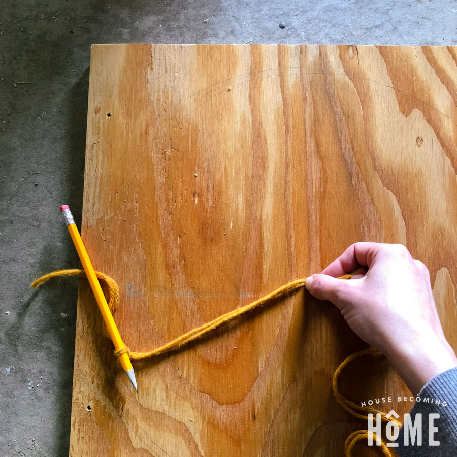 using yarn and pencil to draw a circle on scrap wood