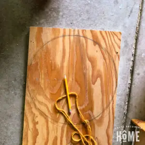 using yarn and pencil to draw a circle on scrap wood