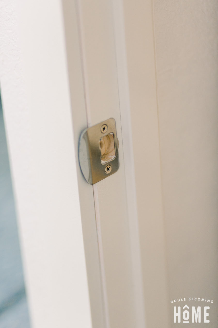 Hole for latch plate on door jamb. Putting on door knob, screwing in latch plate.