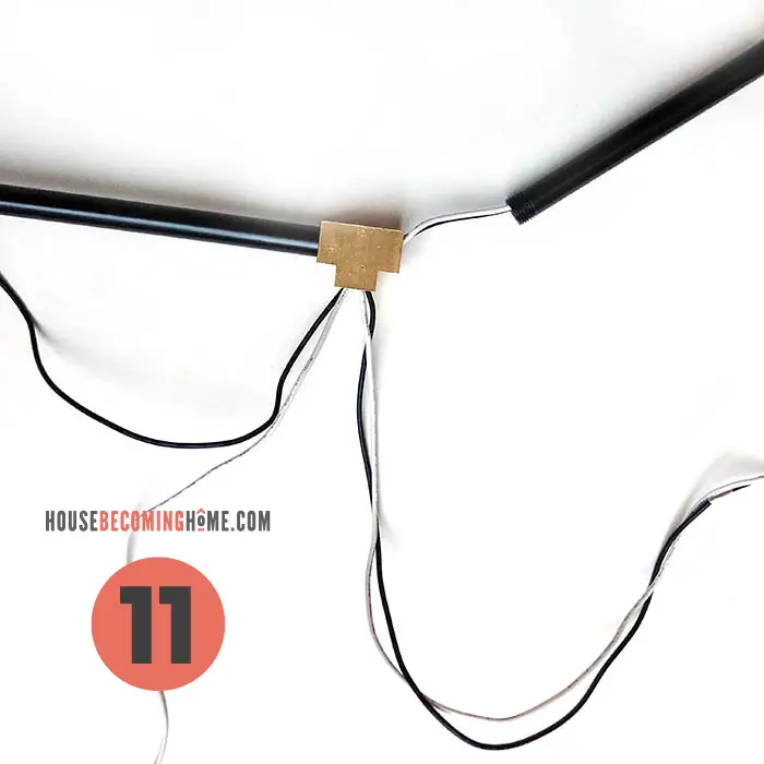 How to make a modern bathroom light fixture. Wires from light socket going through black pipe.