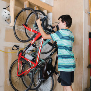 Easy and Cheap DIY Bike Rack. Keep bikes organized while saving space in your garage with this DIY bike rack that costs $10 to make!