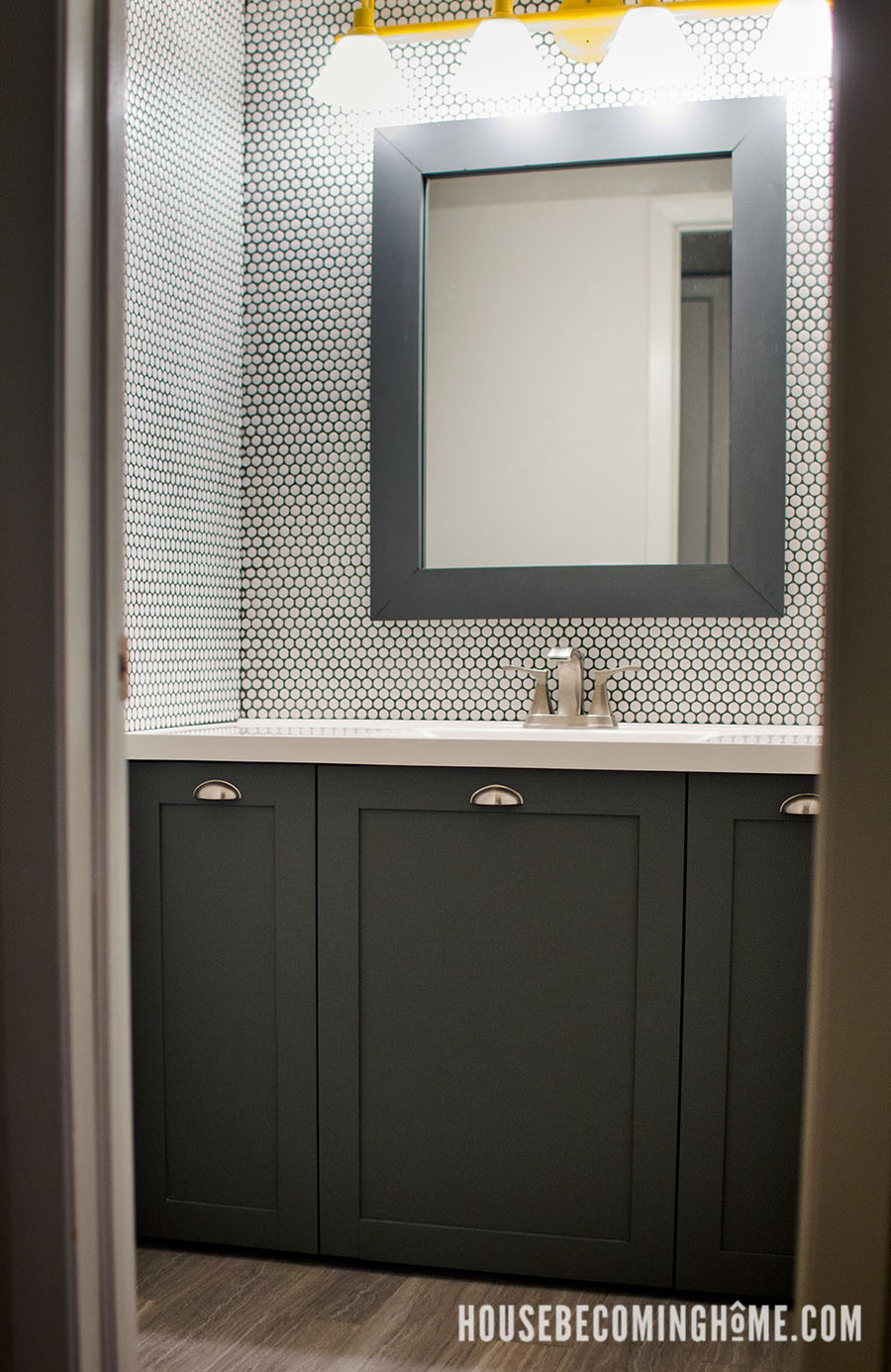 Bathroom with white penny tile wall