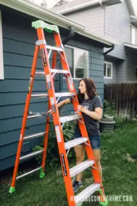 Unfolding Louisville Ladder to Clean Gutters
