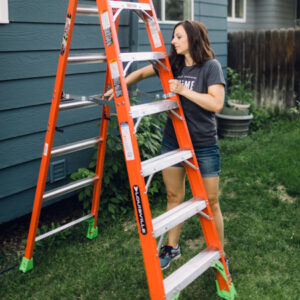 Unfolding Louisville Ladder to Clean Gutters